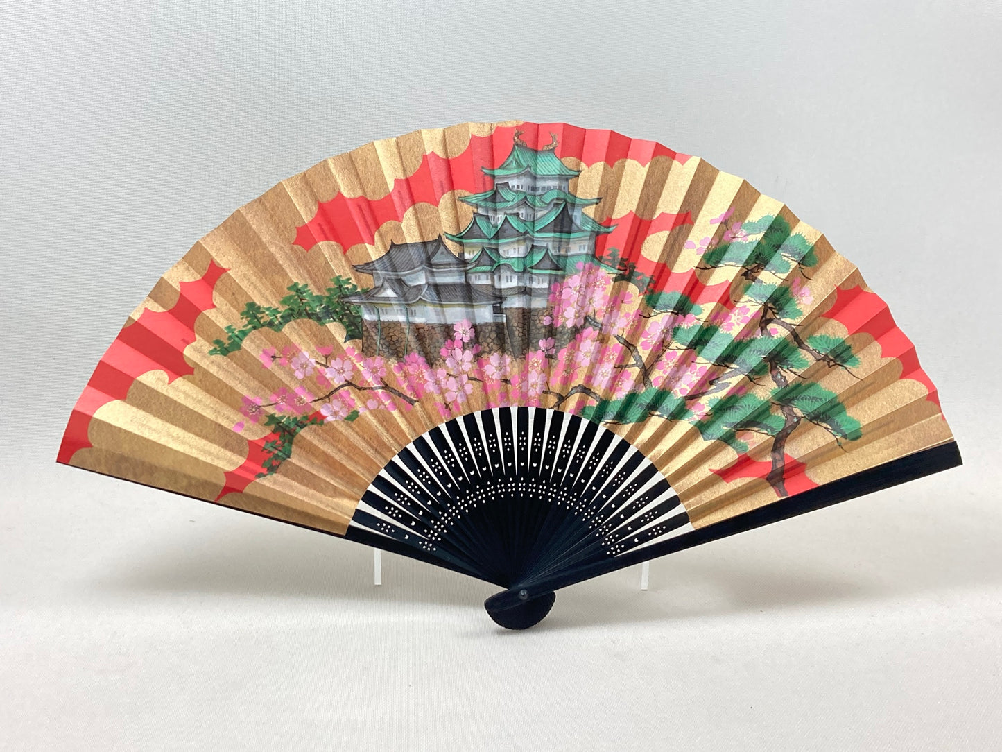 A fan with a picture of Nagoya Castle with cherry blossoms and pine.