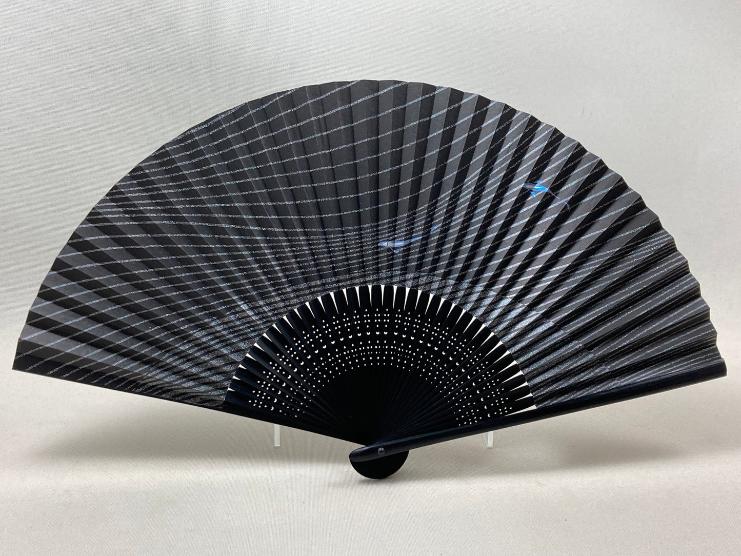 Black fan with a picture of sweetfish with lame