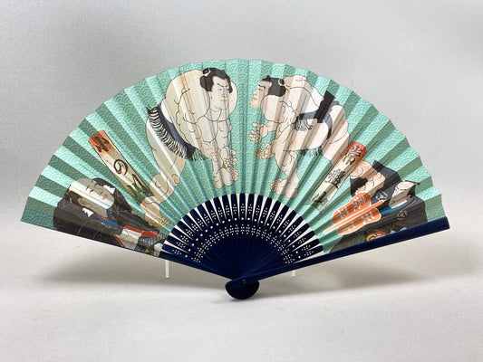 A fan with a pattern of sumo wrestlers wrestling each other